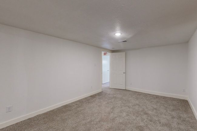 Empty room featuring a textured ceiling and carpet | Image 30