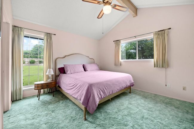 Carpeted bedroom featuring multiple windows and a ceiling fan | Image 16