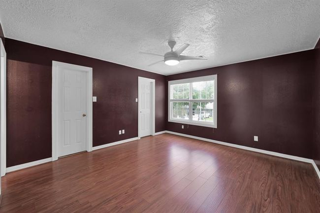 Primary bedroom, at the end of the hall upstairs. Doors pictured are both to a large closet that span the entire space | Image 26