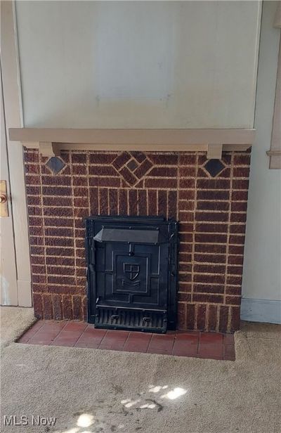 Room details featuring a fireplace and carpet | Image 3