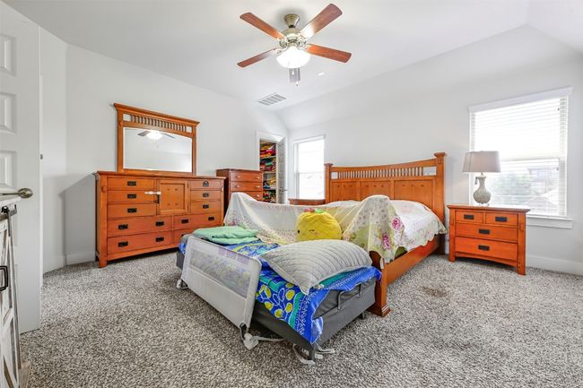 Carpeted bedroom with lofted ceiling and a ceiling fan | Image 16