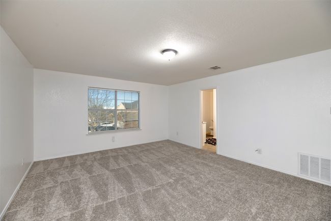 New Carpeted Master bed showing extra large room with visible vents and baseboards | Image 28