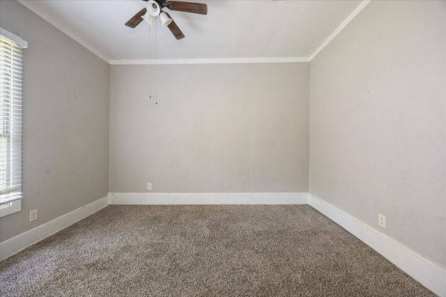 Spare room featuring carpet flooring, ornamental molding, and ceiling fan | Image 10