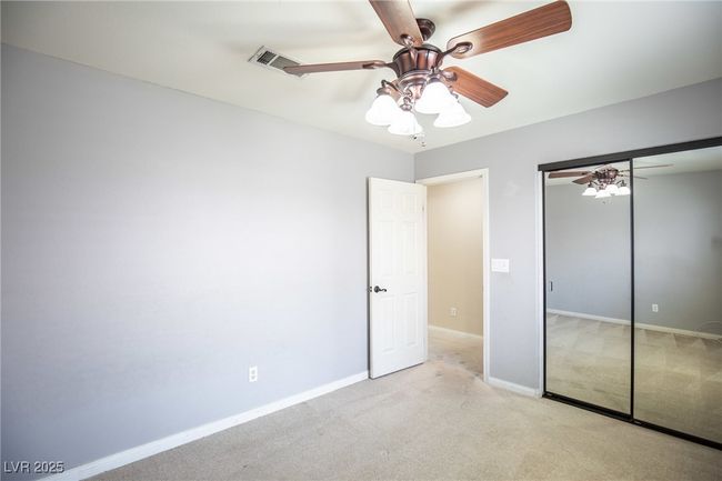 Unfurnished bedroom with ceiling fan, visible vents, a closet, baseboards, and carpet floors | Image 25
