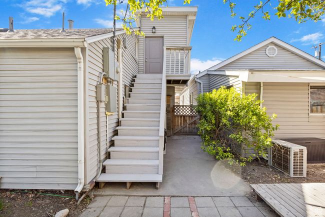 Exterior space featuring cooling unit, a gate, and stairway | Image 52