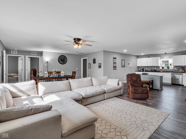 living room with white baseboards, and recessed lighting | Image 4