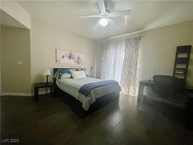 Bedroom featuring baseboards, a ceiling fan, and wood finished floors | Image 27