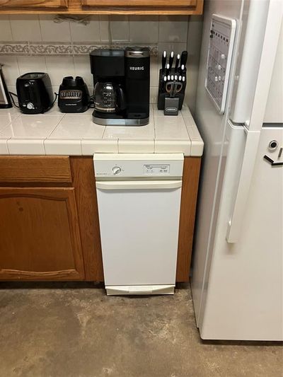 Kitchen featuring fridge and dishwashing machine | Image 2