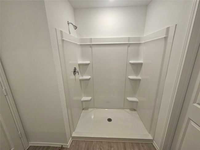 Bathroom featuring a textured wall, a shower, and wood finished​​‌​​​​‌​​‌‌​‌‌​​​‌‌​​‌‌​‌​​​​​‌ floors | Image 19