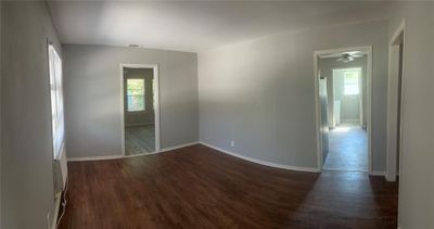 Empty room featuring dark wood-type flooring and ceiling fan | Image 3