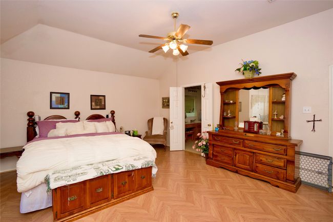 Bedroom featuring vaulted ceiling and a ceiling fan | Image 9