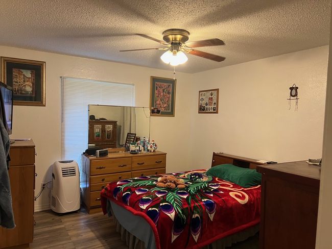 Bedroom with a textured ceiling, ceiling fan | Image 13