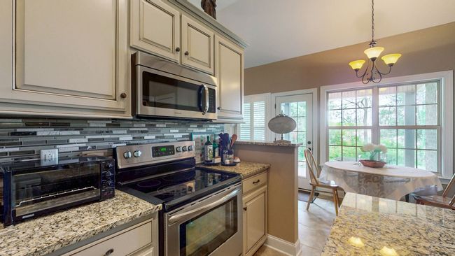 There is a spot in the kitchen for eat-in dining or a quick snack. | Image 11