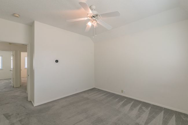 Carpeted empty room with ceiling fan and baseboards | Image 24