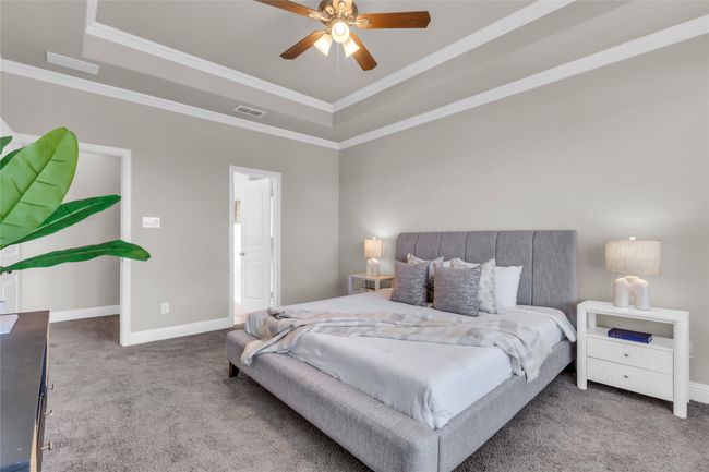 Bedroom with a raised ceiling, carpet flooring, ornamental molding, and baseboards | Image 16