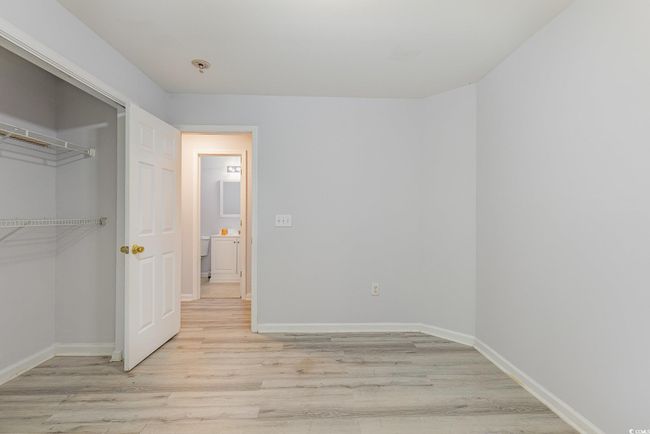 Spare room featuring visible vents, baseboards, and wood finished floors | Image 19