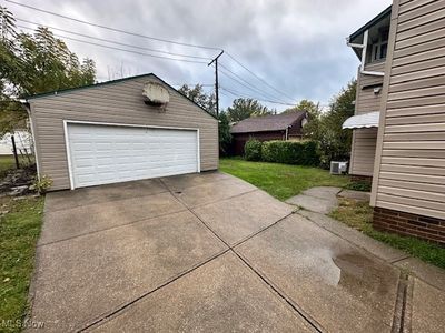 Garage featuring a lawn | Image 2