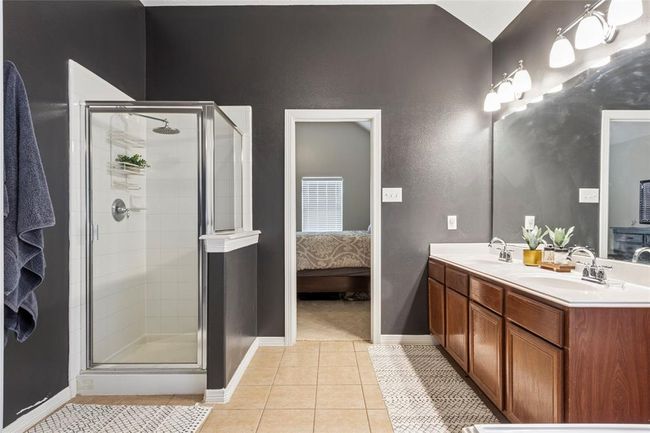 Another view of the primary bath showing the double sinks and shower. | Image 16
