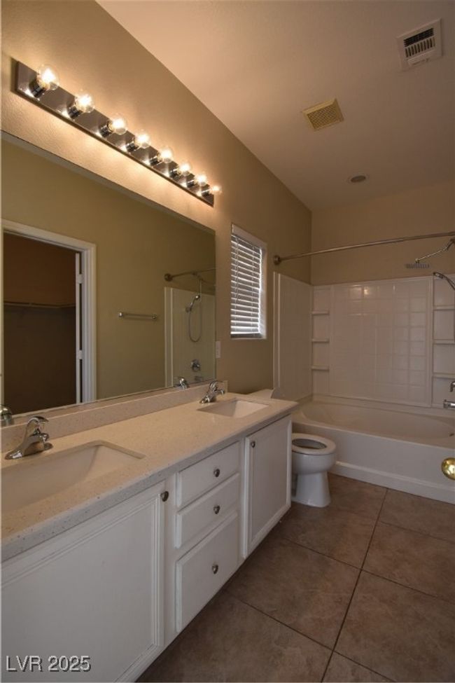 Full bath featuring visible vents, tile patterned floors, toilet, and a sink | Image 22