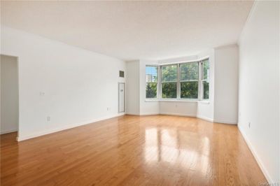 Empty room featuring crown molding and light hardwood / wood-style flooring | Image 2