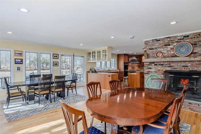 Dining area featuring light wood-style flooring, recessed lighting, and a fireplace | Image 20