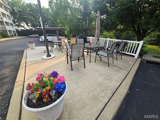 Patio with outdoor dining space behind buildings | Image 29