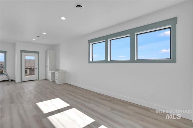 Empty room with healthy amount of natural light, recessed lighting, and light wood-style flooring | Image 21