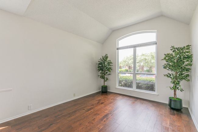 Unfurnished room with vaulted ceiling, dark wood-style floors, and baseboards | Image 9
