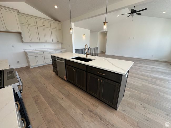 Kitchen featuring vaulted ceiling, dishwasher, light wood-style flooring, a kitchen island with sink, and a ceiling fan | Image 8