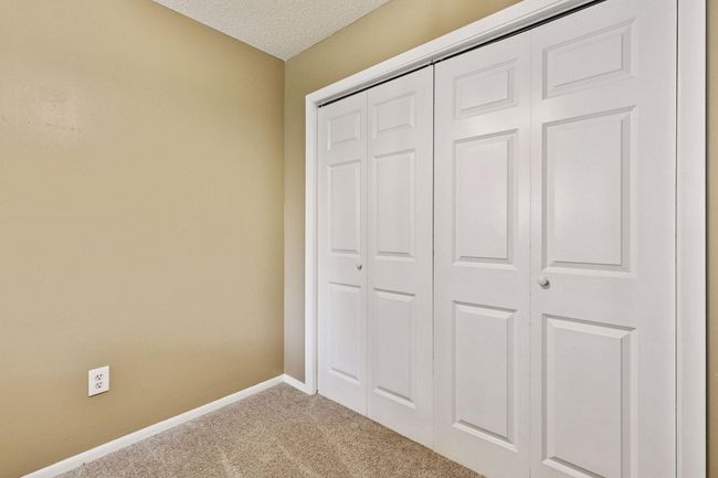 White panelled doors and white trim makes for modern touch. Neutral walls and carpeting throughout this cozy condo! | Image 10