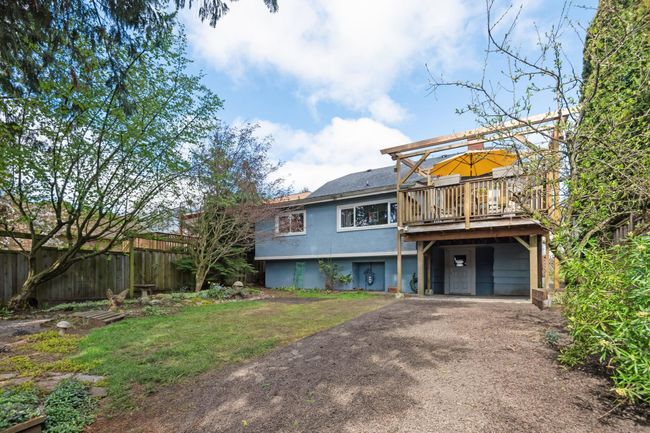 Back of house featuring a deck, a yard, aphalt driveway, and fence | Image 28