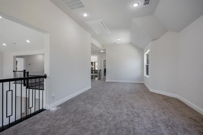 Carpeted empty room with attic access, baseboards, recessed lighting, and vaulted ceiling | Image 26