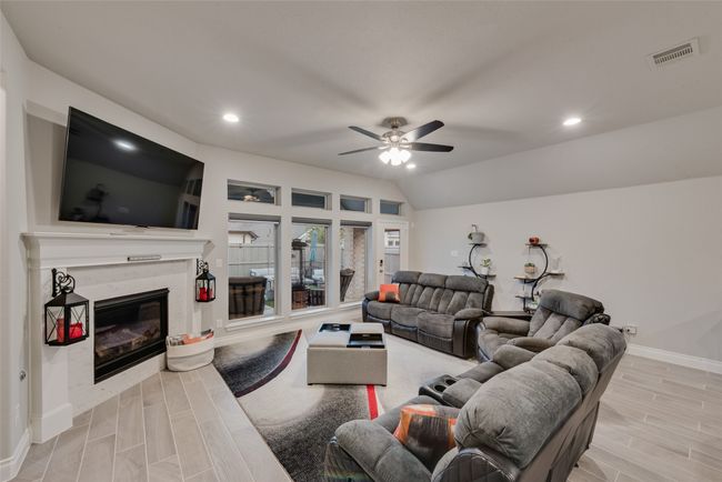 Living room with corner fireplace and large windows | Image 10