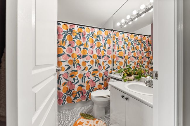 Bathroom with vanity, tile patterned floors, toilet, and a shower with curtain | Image 31