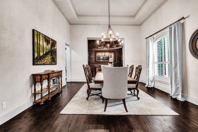 The large and spacious dining room offers an elegant spot to dine with friends and family, Beautifully accented by knotty alder built-in cabinets and wood accent wall. | Image 21