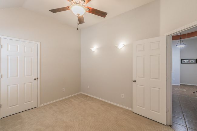 Third bedroom featuring baseboards, lofted ceiling, and a ceiling fan | Image 16