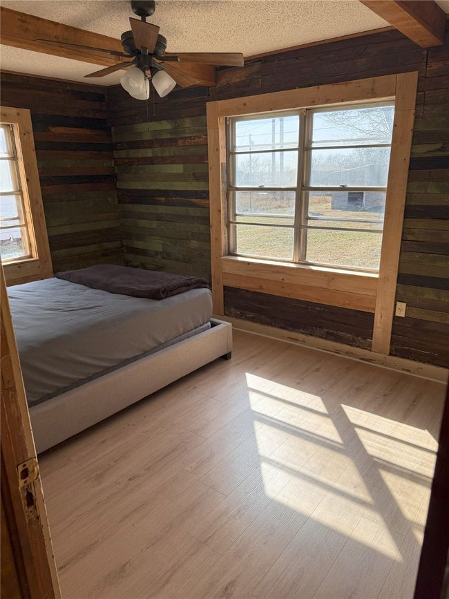 Back Bedroom - Shiplap walls, new flooring and trim, and cedar beams. | Image 17