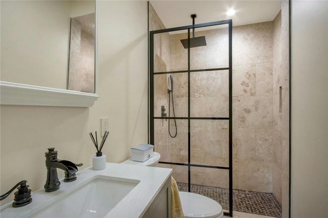Bathroom featuring walk in shower, toilet, and vanity | Image 24