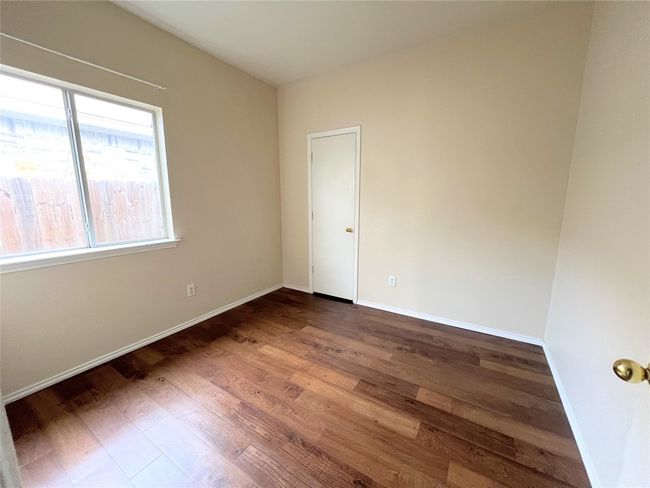 Empty room featuring wood finished floors and baseboards | Image 4