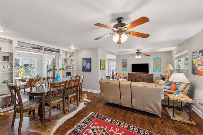 Primary living room with hardwood floors, ample seating, bright natural lighting, smooth ceilings. | Image 31