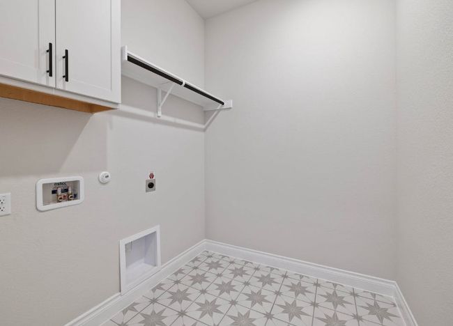 Clothes washing area featuring cabinet space, electric dryer hookup, baseboards, gas dryer hookup, and light floors | Image 21