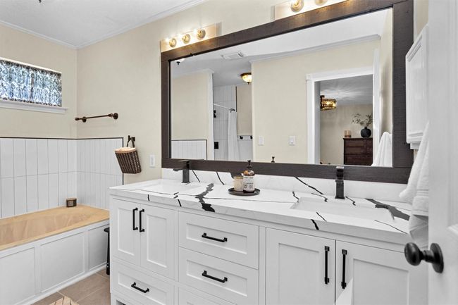 The ensuite bath includes modern fixtures and finishes, creating a spa-like atmosphere perfect for unwinding at the end of the day. | Image 18