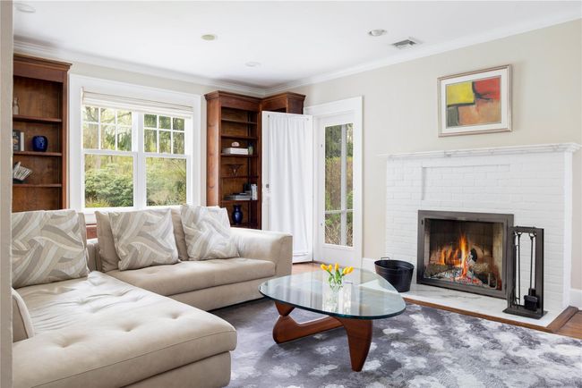 Living room with fireplace and French doors leading to screened porch | Image 7
