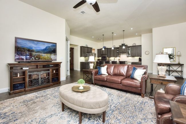Living area with visible vents, baseboards, dark wood finished floors, recessed lighting, and a ceiling fan | Image 12