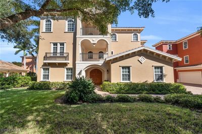 Mediterranean / spanish-style home with a front lawn, a balcony, and a garage | Image 2