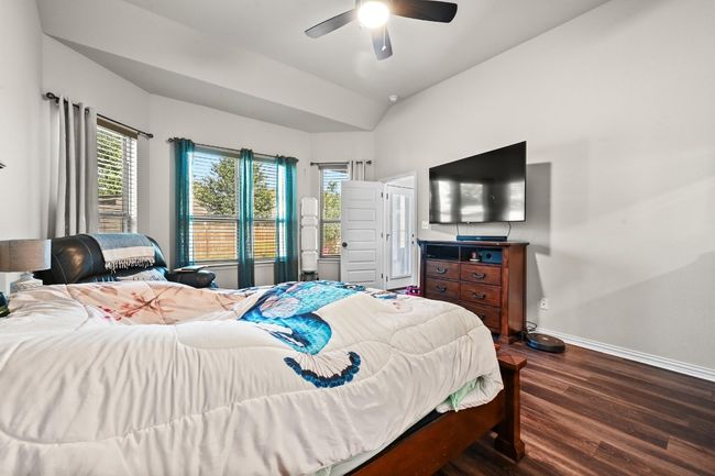 Master Bedroom featuring dark wood-style flooring, multiple windows, lofted ceiling, and a ceiling​​‌​​​​‌​​‌‌​‌‌​​​‌‌​​‌‌​‌​​​​​‌ fan | Image 14