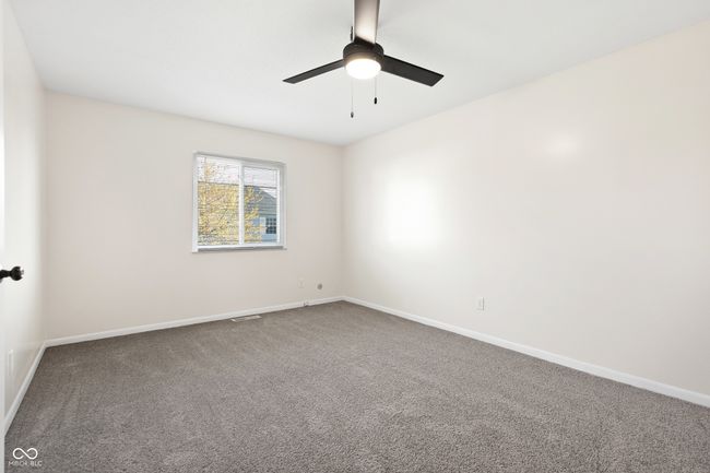 carpeted empty room with baseboards and a ceiling fan | Image 19