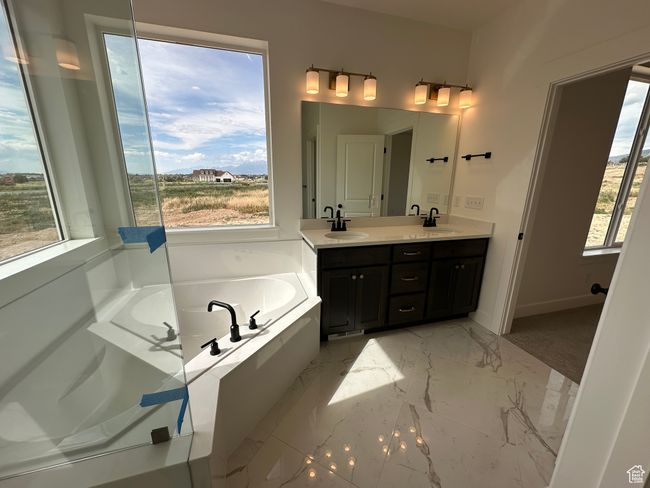 Bathroom with double vanity, a bath, and marble finish flooring | Image 14