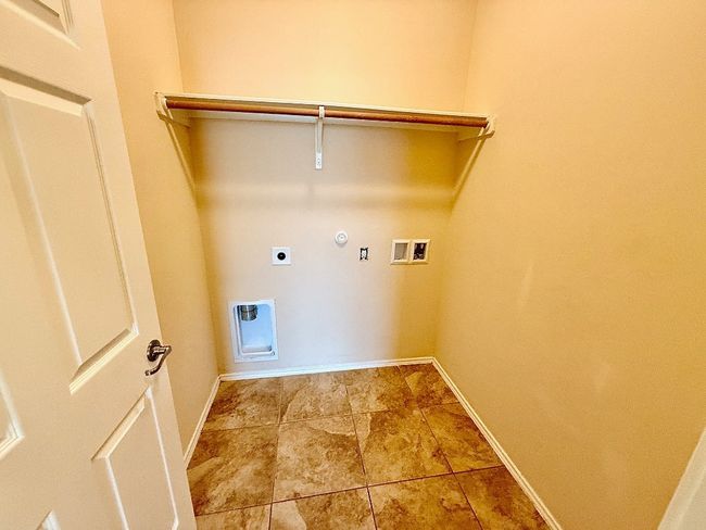 Laundry room featuring electric dryer hookup, gas dryer hookup, and hookup for a washing machine | Image 19