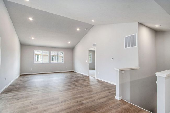 The open concept floorplan has full sight lines into the great room. There is an abundance of natural lighting from windows and is further enhanced by the vaulted ceilings and recessed lighting. | Image 7